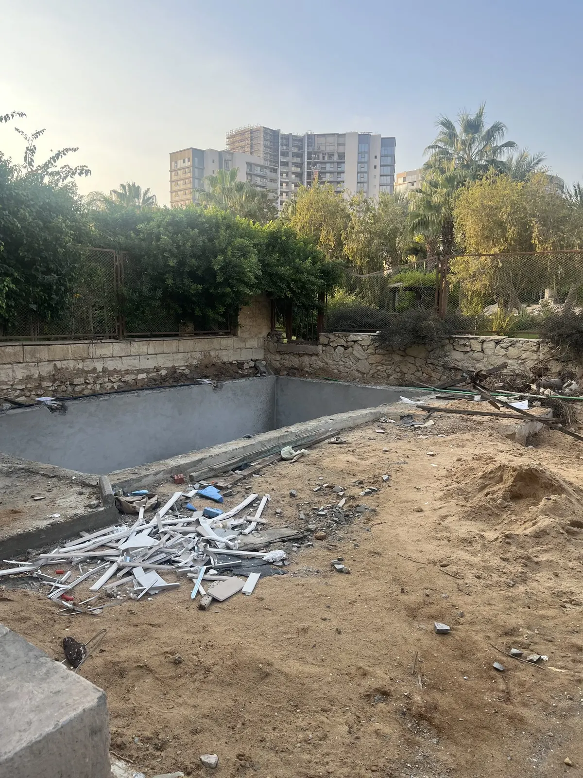 Before: pool shell and garden during works