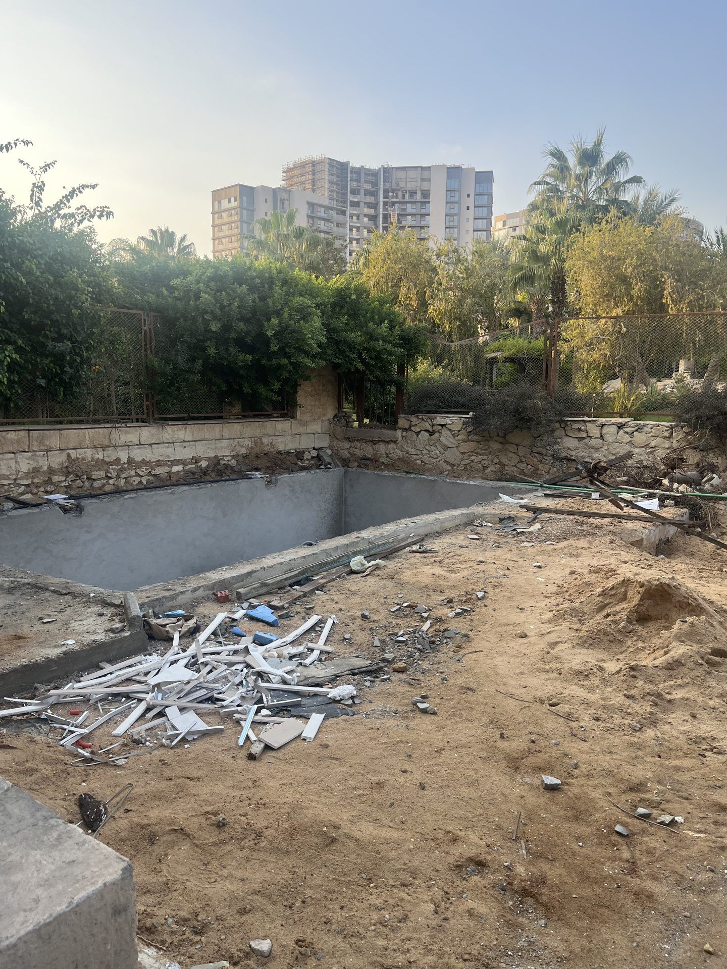 Before: pool shell and garden during works