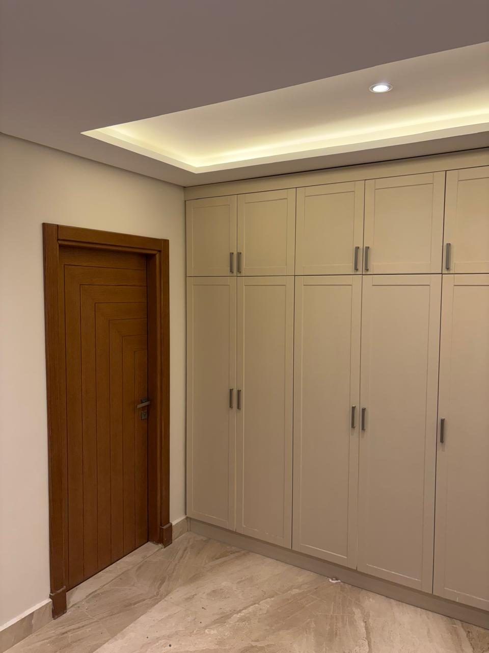 Shaker built-in wardrobes and walnut door