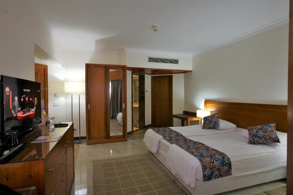 Twin guest room with timber joinery and patterned bed runners