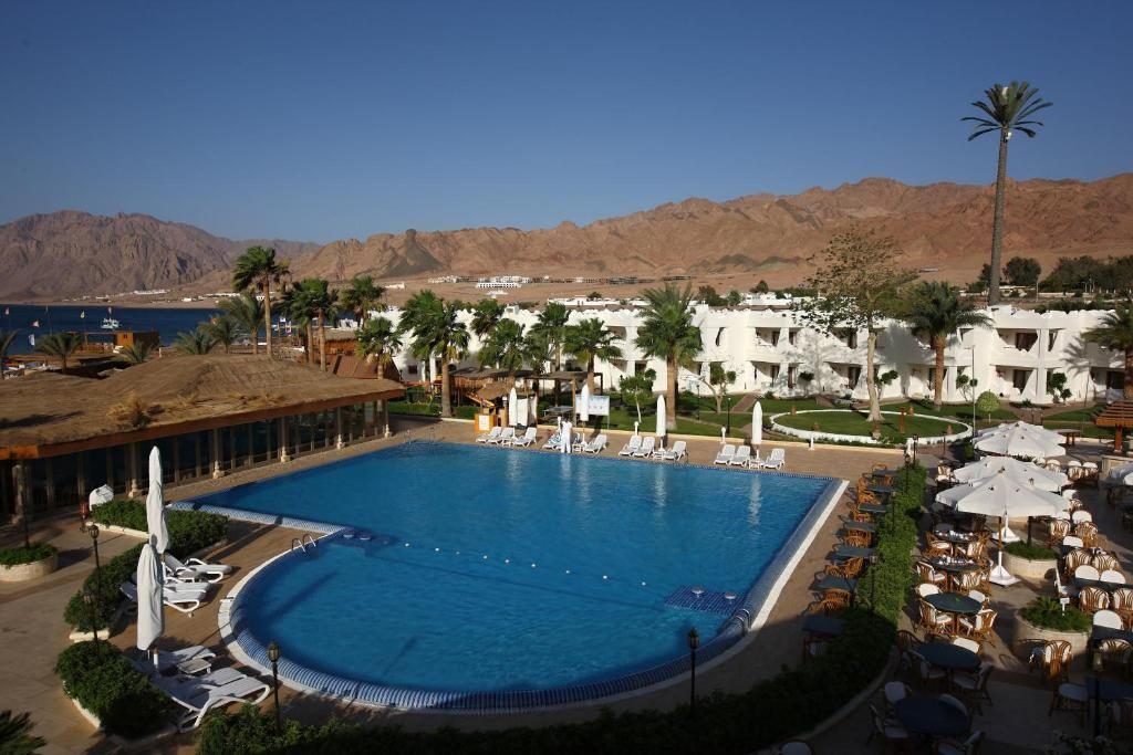 Resort pool and white villas with the Sinai mountains behind
