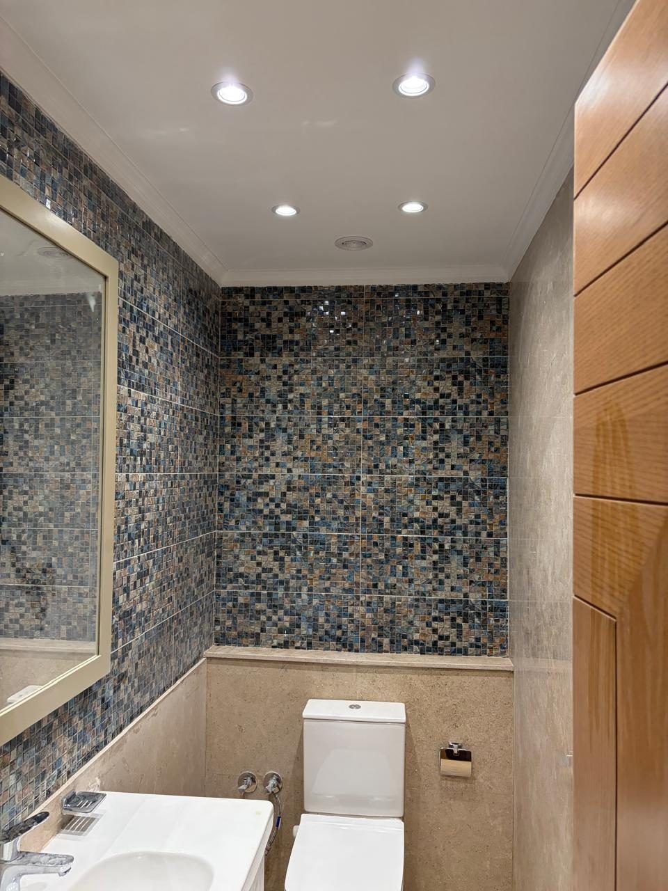 Powder room with blue mosaic feature wall and timber cladding