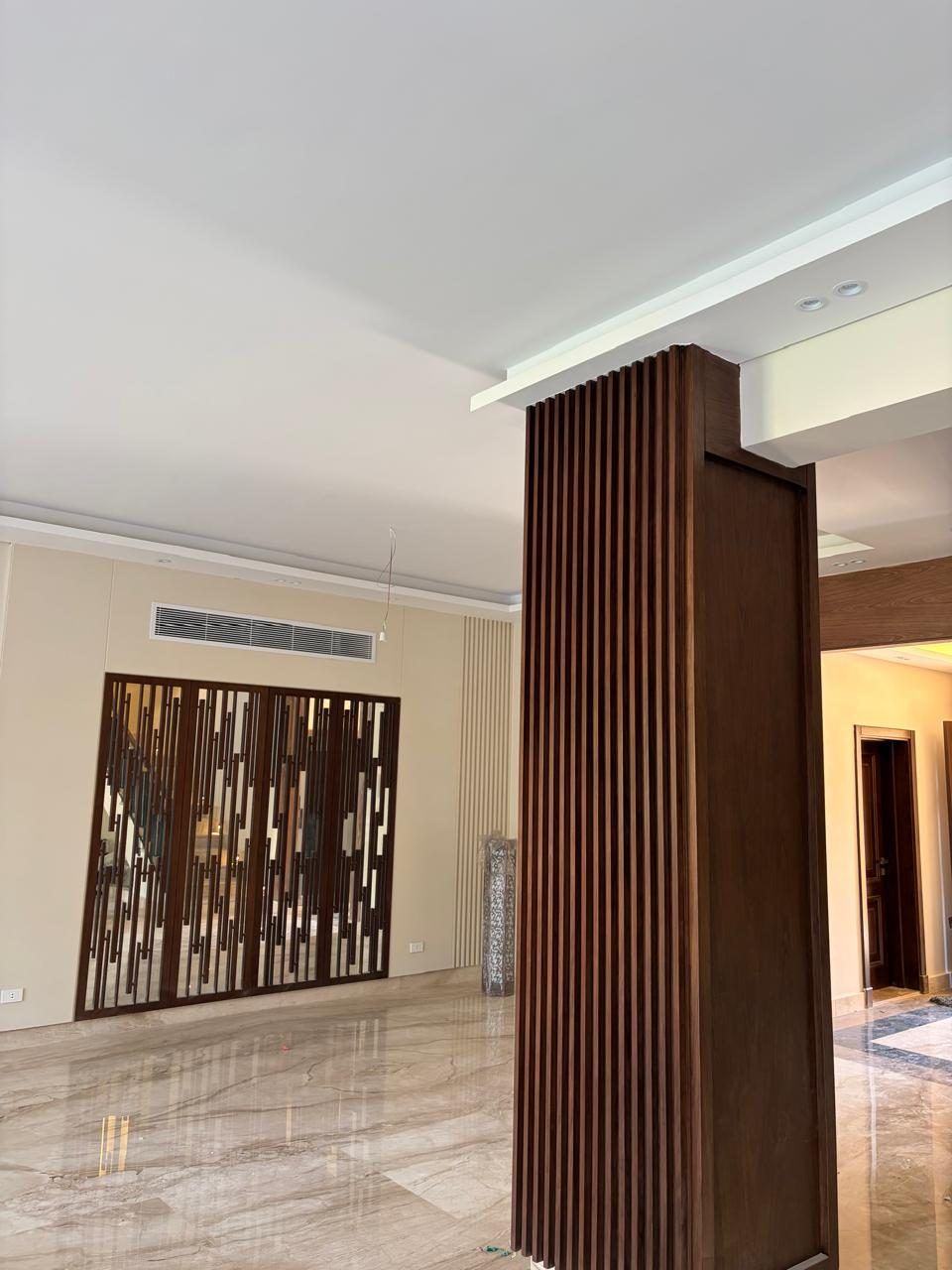 Reception with walnut slat column and laser-cut timber screen