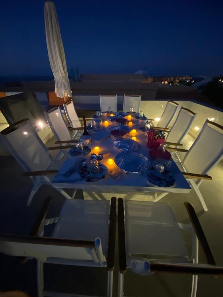 Rooftop dining table set for dinner at night