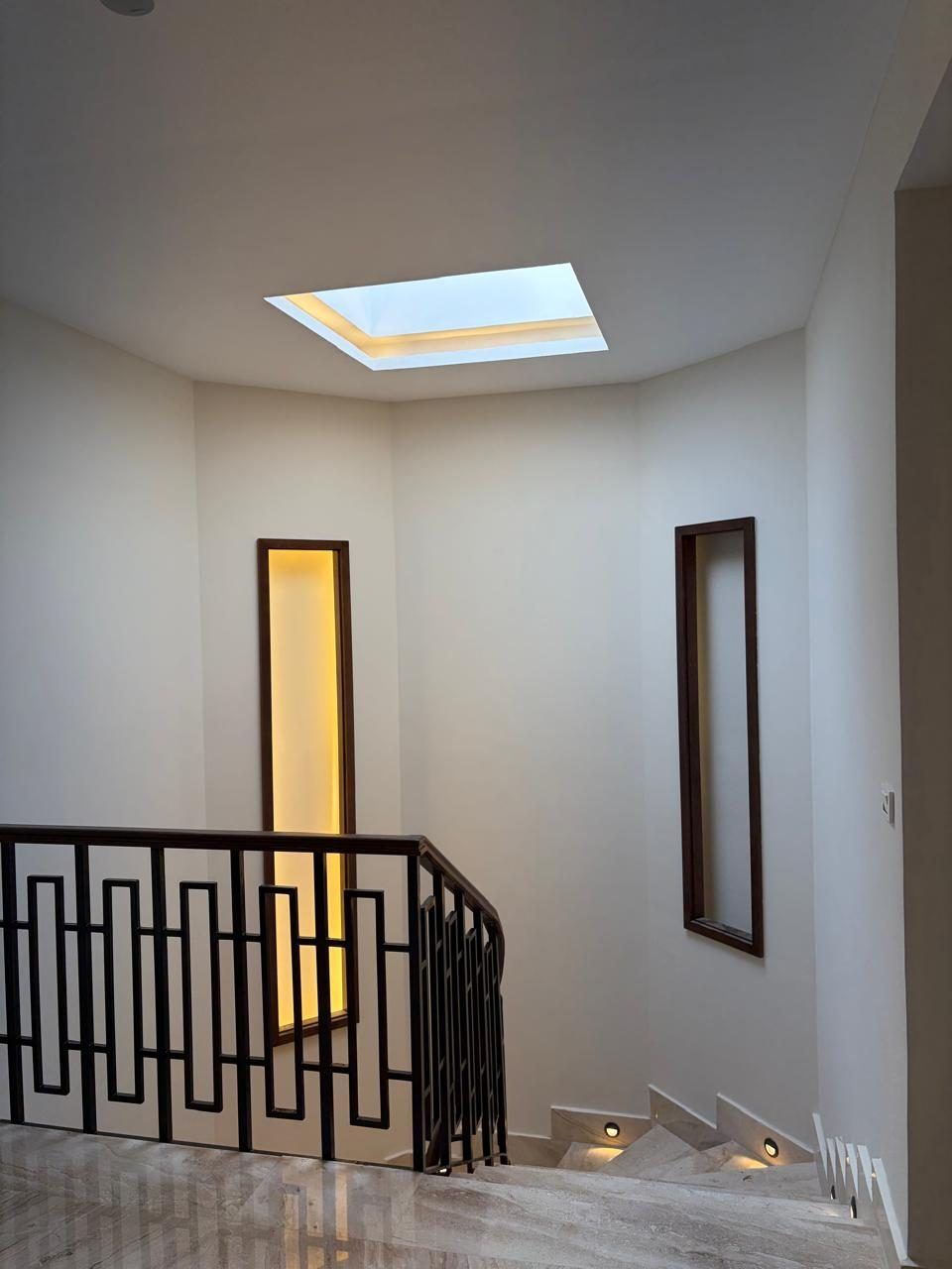 Stair lightwell with skylight and lit wall niches