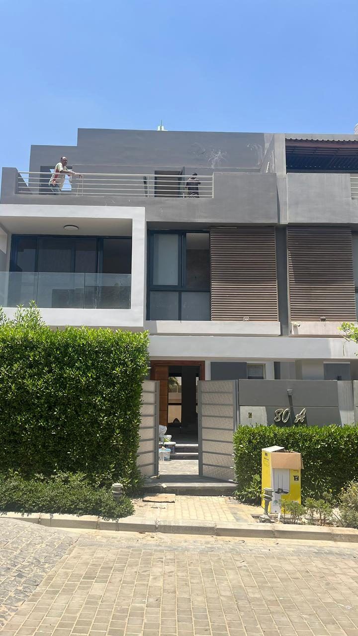 Street elevation with timber screens and planted front garden