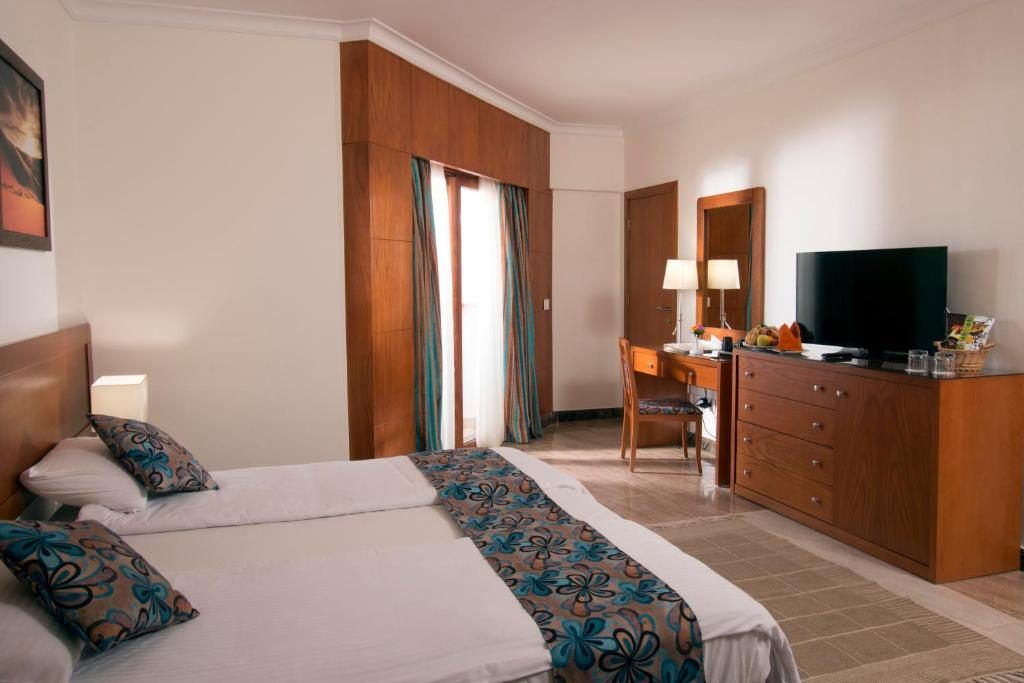 Suite bedroom with timber wardrobe and desk